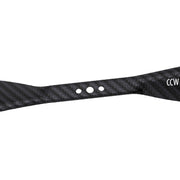 A close-up of a black carbon fiber strap with a woven texture, featuring three circular cutouts and white 'CCW' lettering on the right end, set against a plain white background.