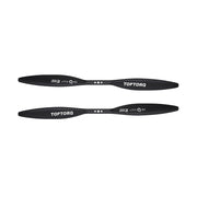 Two black carbon fiber drone propellers with white TOPTORQ branding, displayed horizontally against a solid white background.